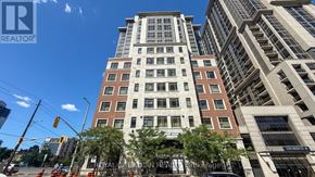 Hamilton (Central) condo for rent - A tall building with a sign that says "Royal Canadian" on it.