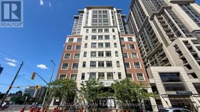 Hamilton (Central) condo for rent - A tall building with a sign that says "REALTOR" on it.