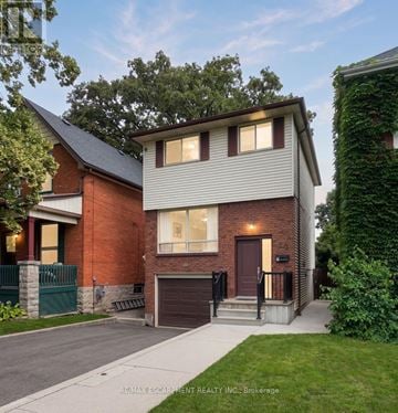 Hamilton (Eastmount) apartment for rent - A house with a red brick exterior and a grey roof is shown.