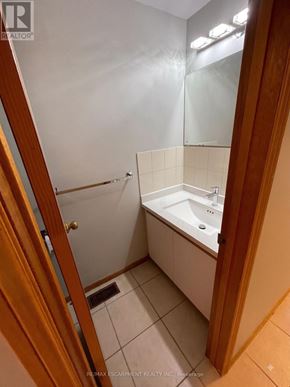 Hamilton (Eastmount) apartment for rent - A bathroom with a white sink and a white bathtub.