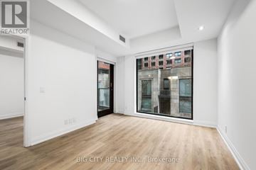 Toronto (Thorncliffe Park) condo for rent - A spacious room with a view of a building outside the window.