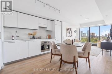 Toronto (Thorncliffe Park) condo for rent - A modern kitchen with white cabinets and a dining table set for four.