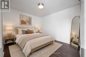 Toronto (Niagara) condo for rent - A bedroom with a bed, nightstands, and a mirror.