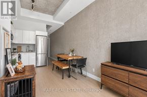 Toronto (Waterfront Communities) condo for rent - A modern kitchen with a wooden table and chairs.