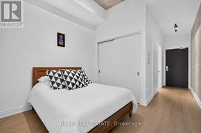 Toronto (Waterfront Communities) condo for rent - A bedroom with a bed, a pillow, and a picture on the wall.