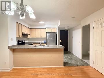 Toronto (Willowdale East) condo for rent - A kitchen with wooden cabinets and a granite countertop.