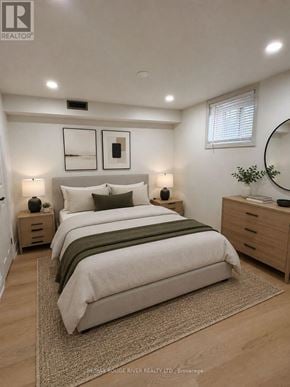Whitby (Downtown Whitby) apartment for rent - A bedroom with a large bed, two nightstands, and a mirror.