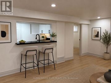 Whitby (Downtown Whitby) apartment for rent - A modern kitchen with a bar stool and a plant.
