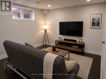 Milton (Sc Scott) apartment for rent - A living room with a grey sofa and a wooden coffee table.