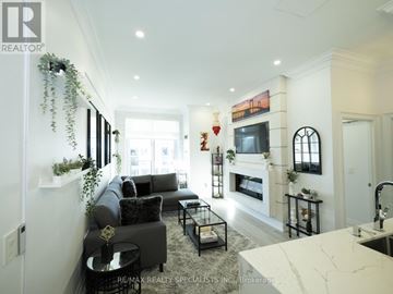 Mississauga (City Centre) condo for rent - A living room with a grey couch and a fireplace.