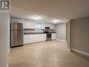 Mississauga (Clarkson) apartment for rent - A kitchen with white cabinets and a stainless steel refrigerator.