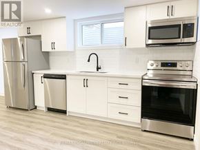 Brantford apartment for rent - A kitchen with white cabinets and stainless steel appliances.