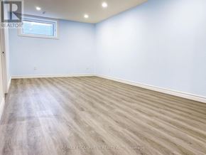 Brantford apartment for rent - A room with light blue walls and wooden flooring.