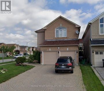 Mississauga (Lisgar) apartment for rent - A house with a brick driveway and a car parked in front.