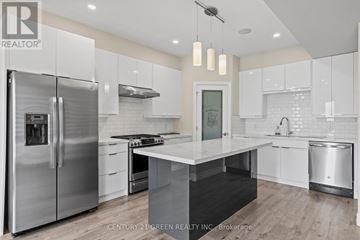 London North (North M) townhouse for rent - A modern kitchen with a stainless steel refrigerator and white cabinets.