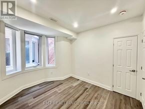 Toronto (Little Portugal) apartment for rent - A room with a white door and windows with a wooden floor.