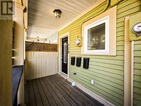 St. John's multi-family for rent - A green house with a black door and a window.