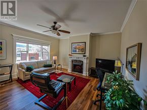 St. John's multi-family for rent - A living room with a fireplace and a television.
