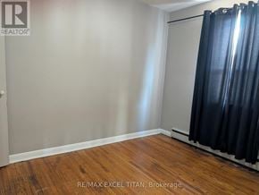 Oshawa (Lakeview) condo for rent - A room with a sliding door and wooden flooring.