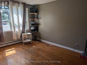 Oshawa (Lakeview) condo for rent - A room with a desk and a window with curtains.