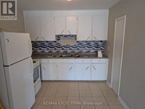 Oshawa (Lakeview) condo for rent - A kitchen with white cabinets and a white refrigerator.