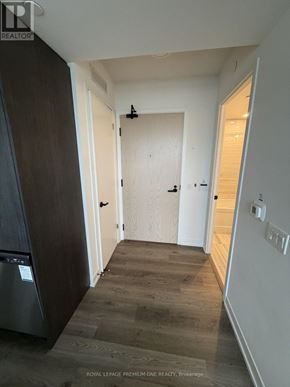 Vaughan (Vaughan Corporate Centre) condo for rent - A hallway with a washer and dryer in the corner.