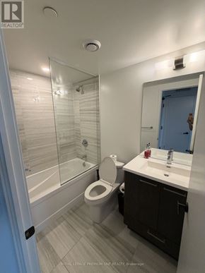 Vaughan (Vaughan Corporate Centre) condo for rent - A bathroom with a toilet, sink, and shower.