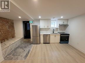 Toronto (University) apartment for rent - A kitchen with a brick wall and stainless steel appliances.