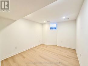 Toronto (University) apartment for rent - A room with white walls and wooden flooring, with a window on the wall.