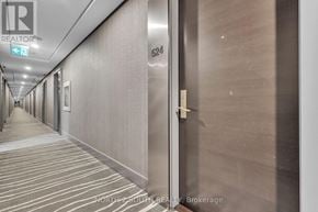 Toronto (Waterfront Communities) condo for rent - A hallway with a sign that says "REALTOR" on the top left corner.