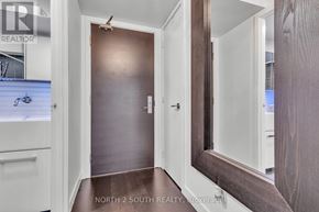 Toronto (Waterfront Communities) condo for rent - A hallway with a brown door and white walls.