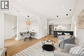Kitchener apartment for rent - A modern living room with a dining area and kitchen in the background.