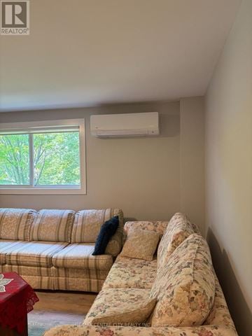 London South (South J) multi-family for rent - A living room with a couch and a window.