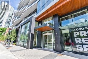 Toronto (Church-Yonge Corridor) condo for rent - A modern building with a glass facade and a bicycle parked in front.