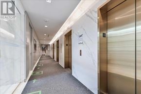 Toronto (Church-Yonge Corridor) condo for rent - A hallway with elevators on the right and doors on the left.