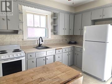 Guelph (St. Patrick's Ward) apartment for rent - A kitchen with a white refrigerator, white cabinets, and a white stove.