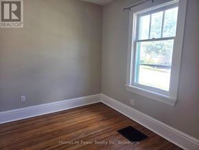 Guelph (St. Patrick's Ward) apartment for rent - A room with a window and wooden flooring.