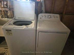 Guelph (St. Patrick's Ward) apartment for rent - A white dryer and washer are sitting next to each other.