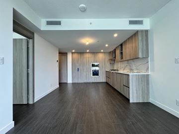 Surrey apartment for rent - A spacious kitchen with wooden floors and cabinets.