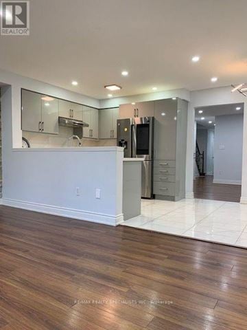 Brampton (Fletcher's Meadow) apartment for rent - A kitchen with a white counter and wooden floors.