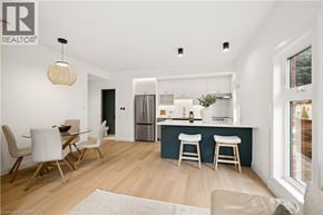 Kitchener apartment for rent - A modern kitchen with a dining table and chairs.
