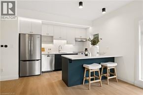 Kitchener apartment for rent - A modern kitchen with a large island and stools.