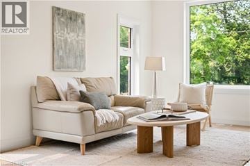 Kitchener apartment for rent - A living room with a couch, a coffee table, and a painting on the wall.