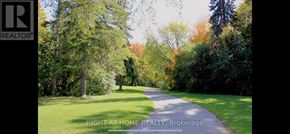 Toronto (Westminster-Branson) condo for rent - A road in a park with the words "Right at Home Realty, Brokerage" written on it.