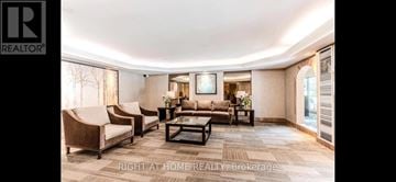 Toronto (Westminster-Branson) condo for rent - A spacious living room with a large couch and a coffee table.
