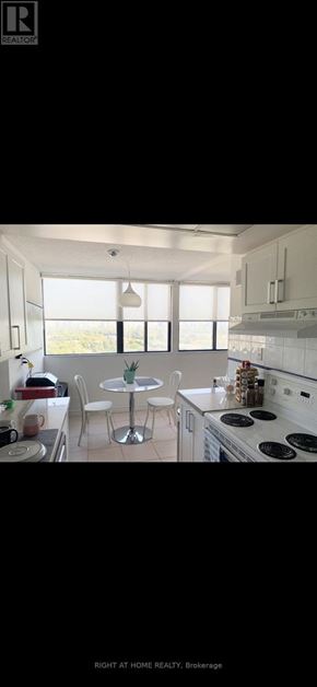 Toronto (Westminster-Branson) condo for rent - A modern kitchen with white cabinets and a large island.