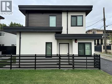 Vancouver apartment for rent - A modern house with a black fence in front.
