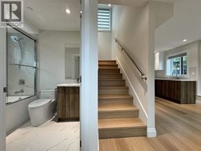 Vancouver apartment for rent - A bathroom with a wooden staircase leading to the second floor.