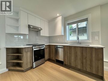 Vancouver apartment for rent - A modern kitchen with wooden cabinets and stainless steel appliances.