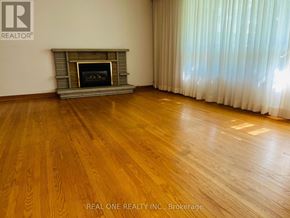 Toronto (Willowdale East) apartment for rent - A room with a fireplace and wooden floors.